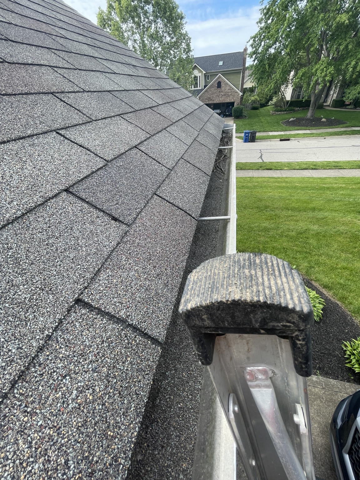Gutter cleaning service on a residential roof