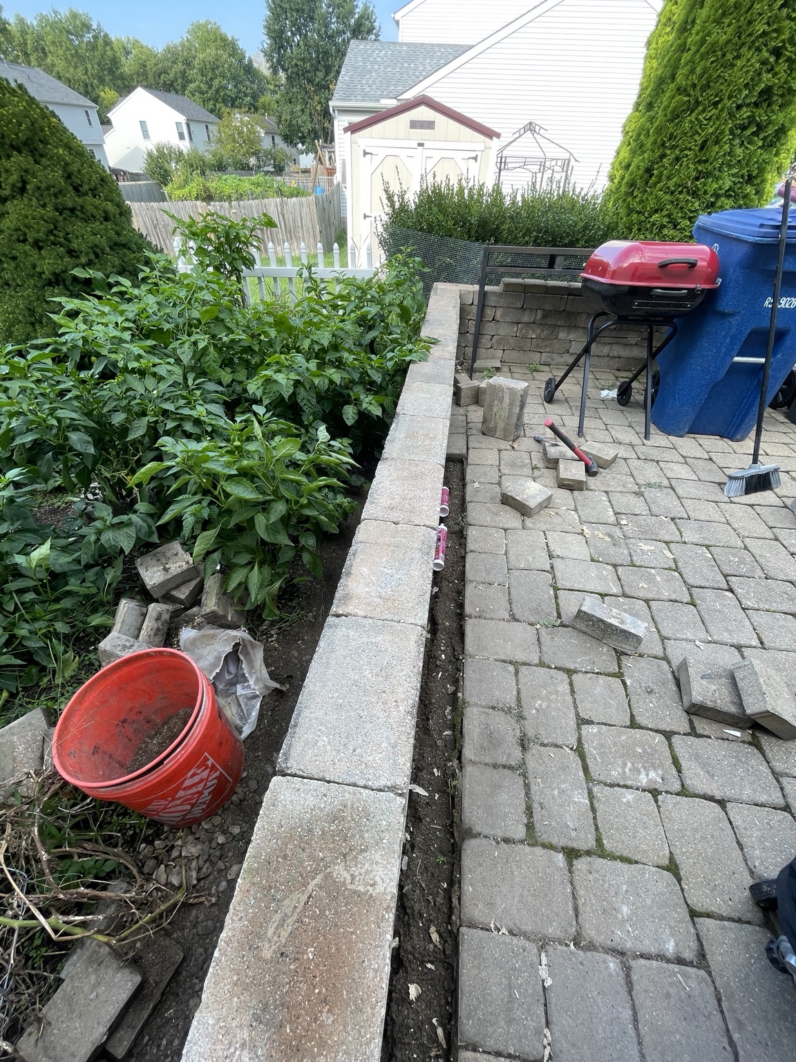 Long patio retaining wall after blocks were reset