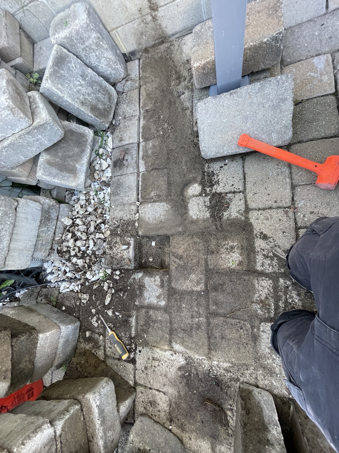 Existing patio blocks removed for base repair