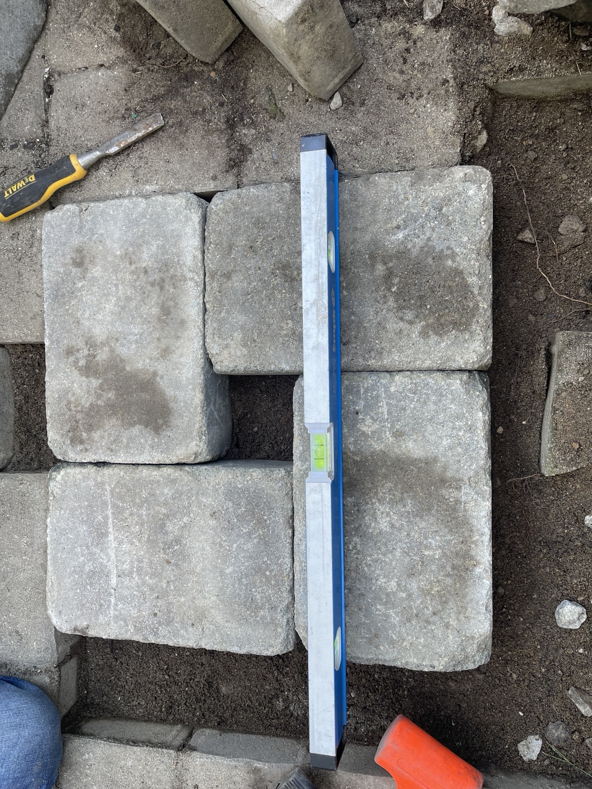 Paver blocks being leveled during repair