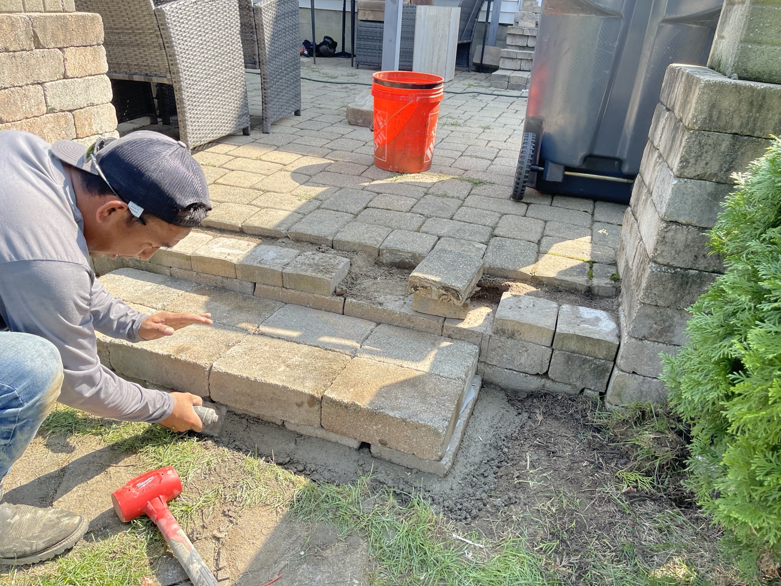 Impact Pro Solutions rebuilding paver steps during a patio repair