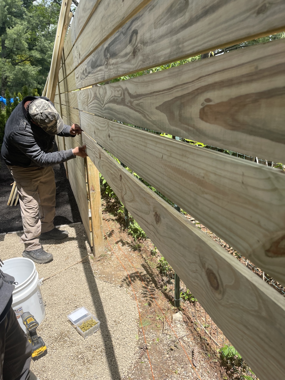 Wood fence section during installation